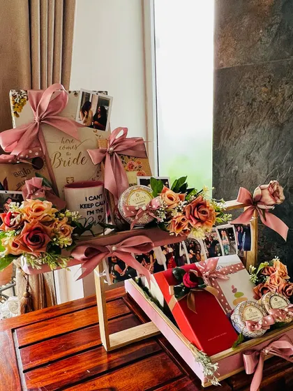 This is one of my most cherished creations, a multi-tiered wedding gift for a best friend. It features personalized elements like a photo reel of shared memories, a custom mug, and curated gifts, all unified by a soft pink and floral theme to celebrate the bride-to-be.