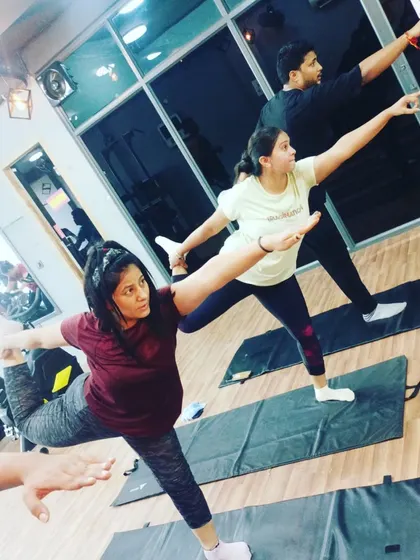 Here, a student practices Natarajasana (Dancer's Pose), a beautiful and challenging pose that improves balance and opens the shoulders and chest.