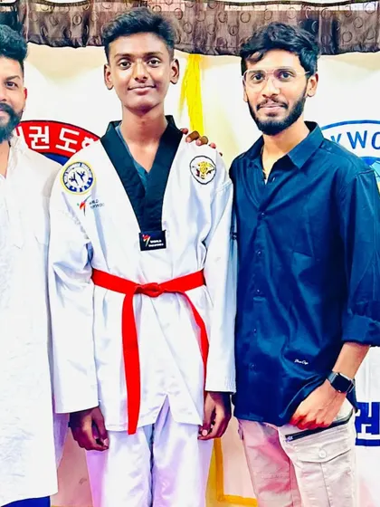 A student celebrates his new red belt.