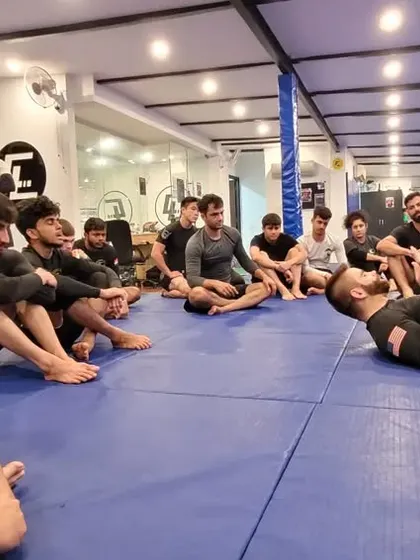A close-up view of a triangle choke being set up. In our seminars, everyone gets a clear view of the mechanics, ensuring no detail is missed.