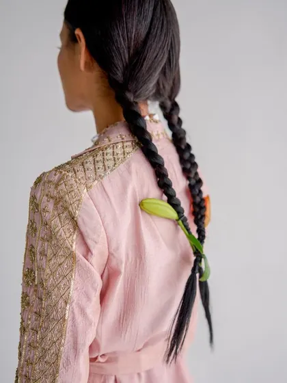 Another hair detail from the same shoot, this time weaving a lily bud into twin braids. These small touches are what elevate a look.