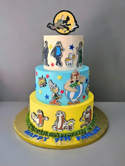 A comic book lover's dream cake for Parijat's 7th birthday. This three-tier butterscotch cake features characters from Tintin, Asterix, and Calvin and Hobbes.