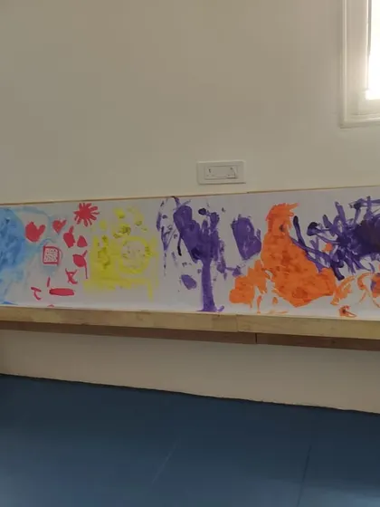 The finished mural is a vibrant testament to their teamwork and individual expression. This abstract piece showcases a variety of colors and brushstrokes, capturing the energy of the session.