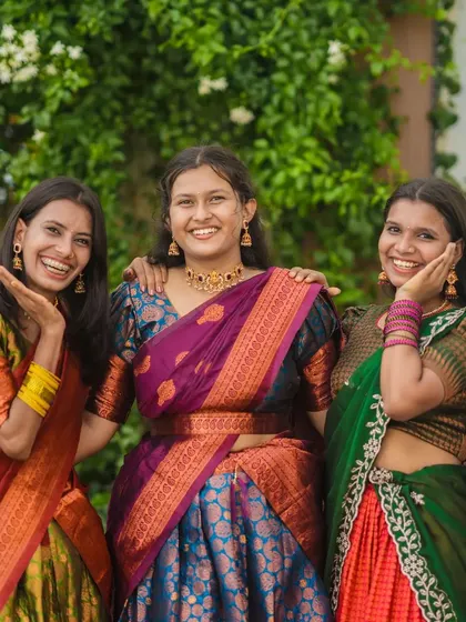 Capturing the fun and playful side of friendships. This candid shot shows three friends in traditional wear having a great time.