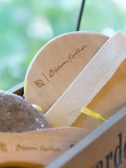 Quality tools for your self-care routine. This close-up shows our wooden body polisher and natural stone, perfect for gentle exfoliation.