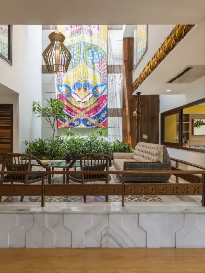In the Ashraya Residence, a raised platform in the central courtyard offers a cozy nook for family gatherings. Every material, from the Jaisalmer stone flooring to the carved wooden columns, is sourced from India, reflecting a design ethos rooted in authenticity.