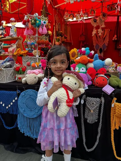 A precious moment with one of our youngest fans at an exhibition. She instantly fell in love with this large, soft mushroom plushie. All our toys are designed to be safe and huggable for children of all ages.
