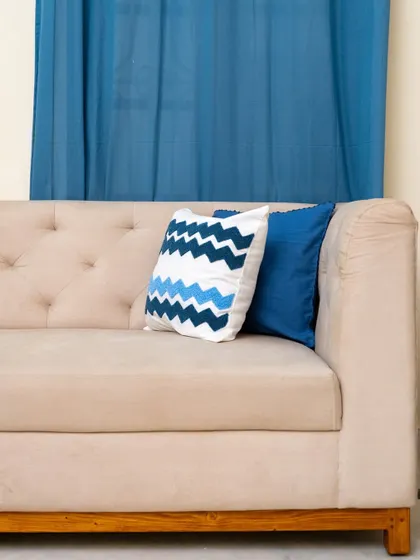 A close-up of the sofa's arm and back, highlighting the clean lines and the comfortable, deep seating that we prioritize in our upholstered furniture.