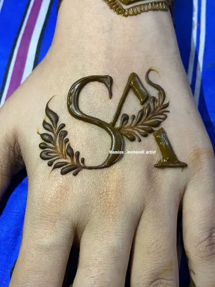 A close-up of custom initials 'S' and 'A' with a delicate leafy design, perfect for a minimalist touch.