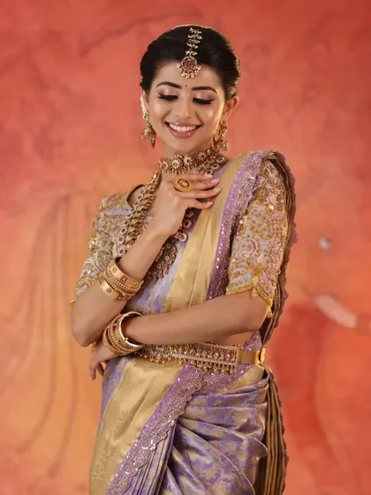 A beautiful shot of the model, her smile and pose capturing the elegance and grace of the entire outfit.