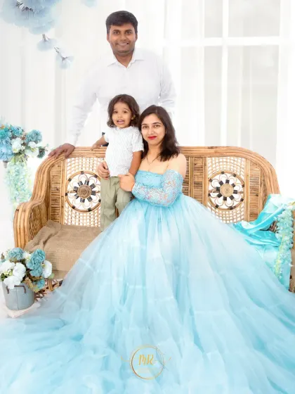 A beautiful family portrait from a blue-themed session. The mother's flowing gown and the coordinated colors create a cohesive and artistic look.