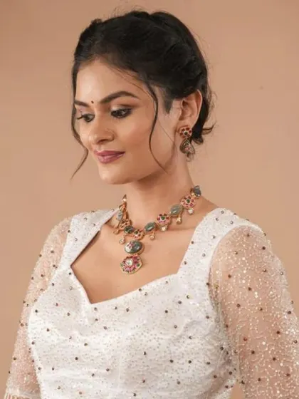 A repeat of the sparkling white blouse, here paired with a beautiful multi-colored stone necklace.