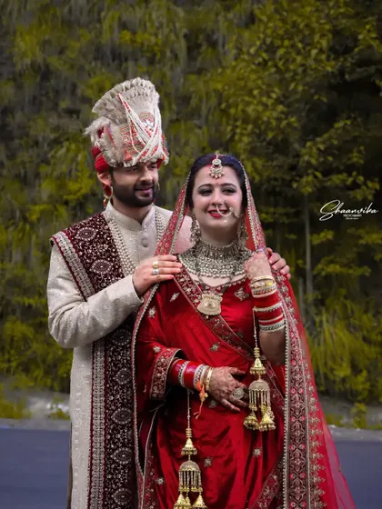 A lovely portrait of the groom with his hands on his bride's shoulders. This pose is both classic and intimate, showing the strong bond between the couple.
