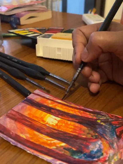 A close-up of my brushwork on a small, imaginative landscape. It's all about playing with colour and light.