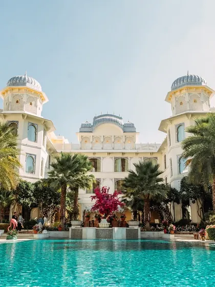 The majestic Leela Palace Jaipur, providing a royal backdrop for the vibrant poolside Haldi celebration.