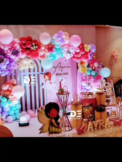 Another angle of Ayra's colorful fairy-themed party, showing the dynamic arrangement of balloons and props. The 'Happy Birthday' neon sign adds a modern touch.
