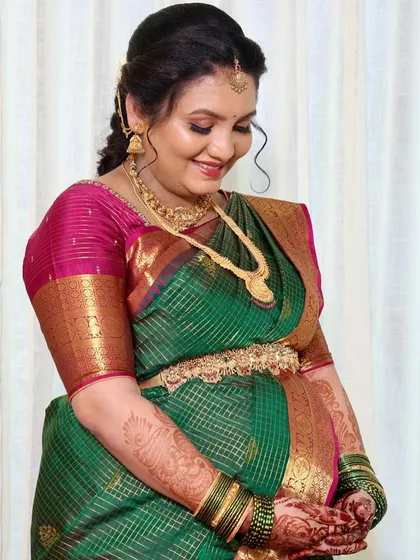 A close-up of the happy mother-to-be. This shot captures the soft details of her makeup and the joy in her expression during her baby shower celebration.