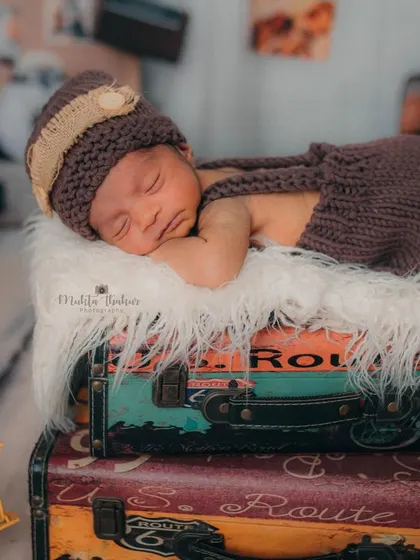 A slightly wider view of the setup, showing how all the travel-themed props come together to frame the sleeping baby, creating a whimsical and imaginative portrait.