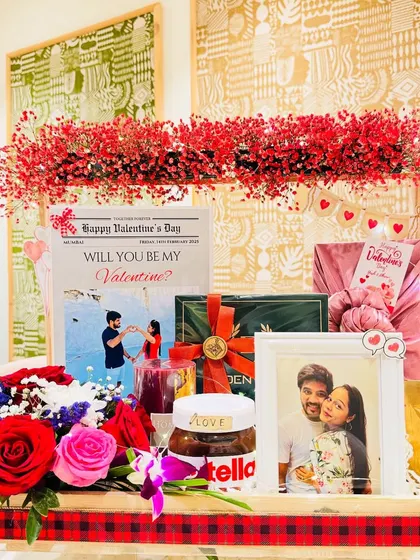 Another perspective of the Valentine's hamper, showing the balance between the floral arrangement, the personalized items, and the indulgent treats.