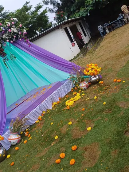 A tilted shot showing the vibrant colors of the Mehendi teepee against the green lawn.