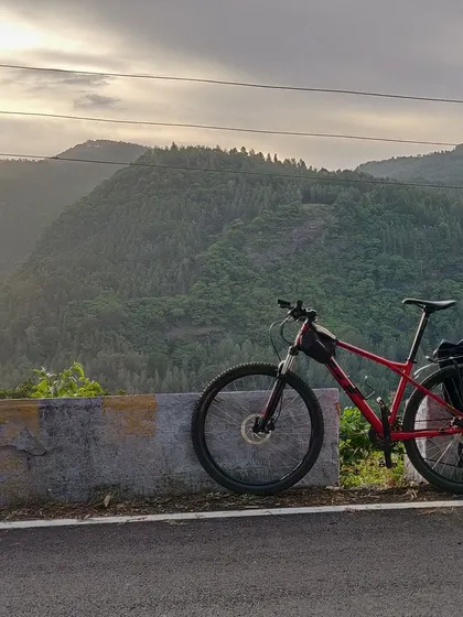 A bike rests against a barrier, overlooking the dense forests of Yercaud. This shot captures the feeling of being on top of the world, surrounded by nature.