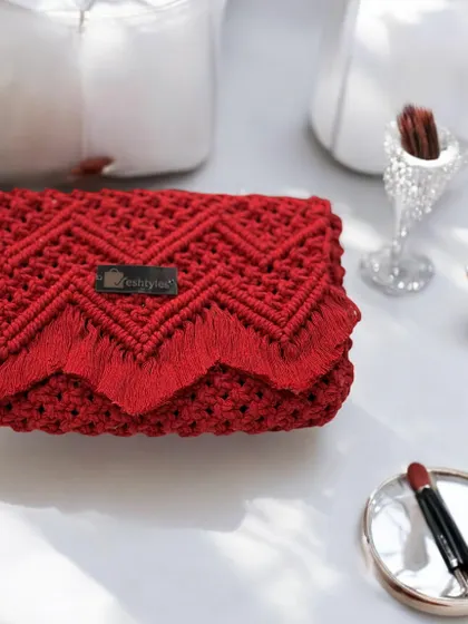 A stunning red clutch with a chevron pattern and scalloped fringe. It's the perfect accessory for a glamorous night out.