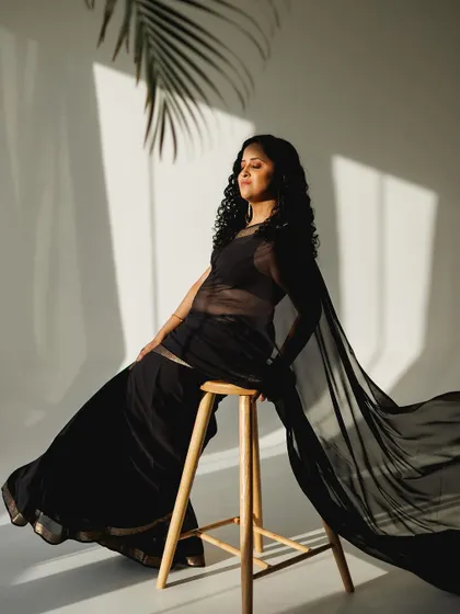 Another artistic shot from the modern black saree session, playing with light and fabric.