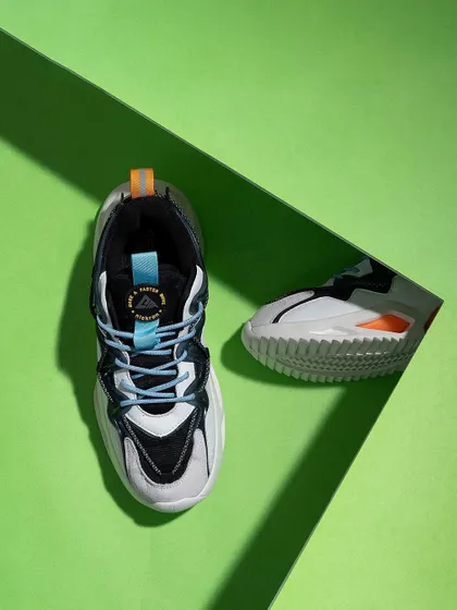 A top-down shot of sneakers on a bright green background with a strong shadow line. The graphic composition and complementary colors make this a bold and eye-catching image.