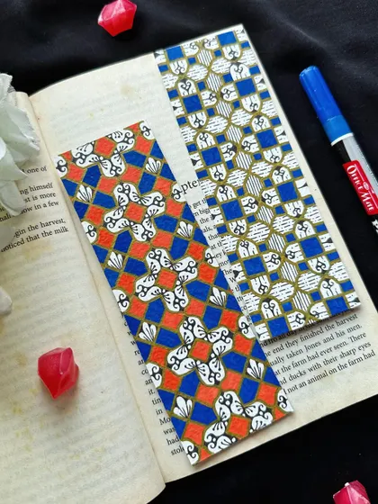 No matter how hard the past, you can always begin again. Two more geometric bookmarks, one in a vibrant orange and blue, and the other in a more subtle blue and gold.