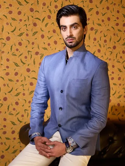 The quiet power of a well-cut silhouette. This blue bandhgala-style jacket is crafted from 100% Irish linen, redefining summer style with both comfort and sartorial elegance.