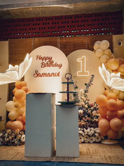This is the full view of the artistic butterfly setup, showing how the elements come together. The dual backdrops, plinths for the cake, and soft lighting create a balanced and beautiful composition.