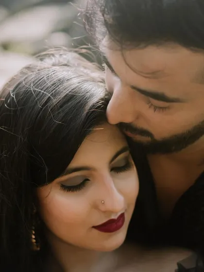 A beautiful close-up shot of a groom kissing his bride's forehead during their pre-wedding session.