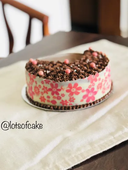 Another angle of the chocolate ganache cake, highlighting the delicate pink sugar pearls that add a touch of elegance.