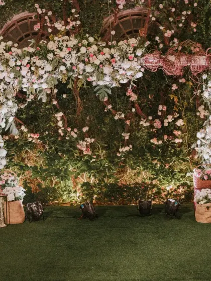 We created an enchanting garden setting for this post-wedding soiree. The floral arch, set against a wall of lush greenery, served as a beautiful photo backdrop and focal point for the evening's celebrations.
