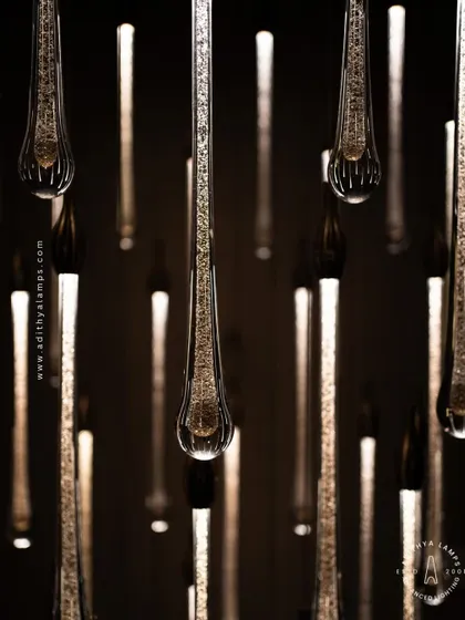 A stunning cluster of crystal teardrop pendants. Each pendant contains bubble-like inclusions that catch the light, creating a sparkling, rain-like effect. This is an elegant choice for double-height foyers or modern staircases.