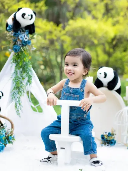A happy toddler enjoys a ride on a toy during his outdoor-themed photoshoot. These sessions are full of energy and movement, perfect for active little ones.