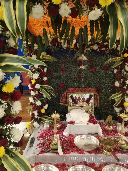 The beautifully decorated stage for a Rupaande Maa Pahedi performance at Yogi Sabhagrah. The sacred setup with flowers and the deity's image creates the perfect atmosphere for a night of devotion.
