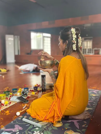Here, I am playing a handheld Tibetan bowl, moving around the room to allow its vibrations to interact more personally with each participant. This technique is a form of vibrational sound therapy.