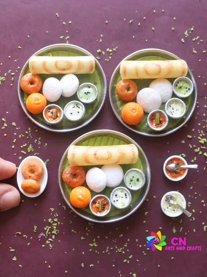 A close-up of a South Indian breakfast platter featuring dosa, idli, vada, and kesari. These miniatures are perfect as collectible fridge magnets or unique gifts for food lovers.