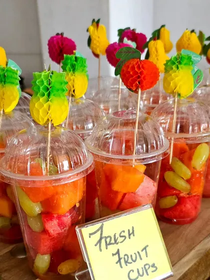 Cute and colorful fresh fruit cups, a healthy and refreshing snack or dessert option, especially for summer events and kids' parties.