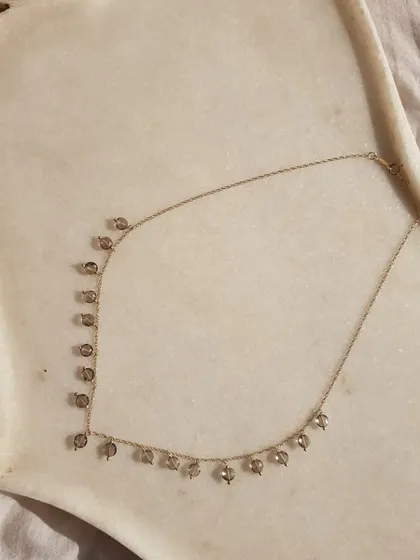 The 'hrasvá' Smoky Quartz Coin Choker, as seen on Sanya Malhotra. This grounding stone brings emotional calmness and relieves stress and anxiety.
