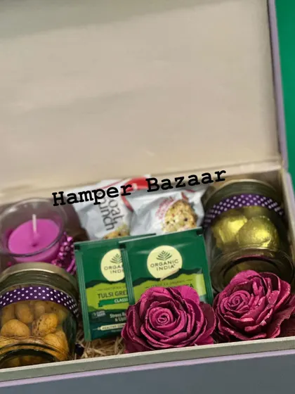 An inside look at one of our popular corporate wellness hampers. This box is curated with health in mind, featuring flavored foxnuts, truffle chocolates, Organic India green tea, oats cookies, and a scented candle for relaxation.