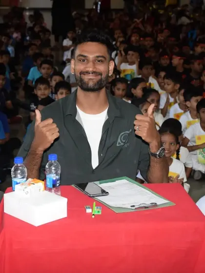A view from the judge's seat. Surrounded by an enthusiastic young audience at St. Anne's High School, Percy gives a thumbs-up, ready for the next performance. We believe in creating a positive and supportive environment for every dancer.