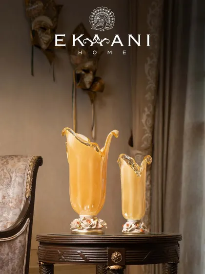 This pair of Murano glass vases, with their unique organic shapes and porcelain rose bases, showcases the quiet drama of Venetian heritage. No two pieces are ever the same, each carrying the delicate fingerprint of its maker.