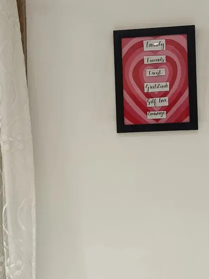 The finished heart-themed wall frame hanging in its new home.
