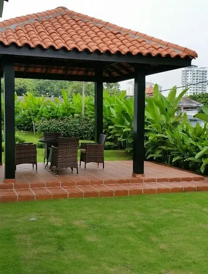 For larger gardens, we build classic wooden gazebos like this one. With a traditional tiled roof and a raised terracotta floor, it provides a perfect, shaded focal point for family gatherings or a quiet afternoon outdoors.