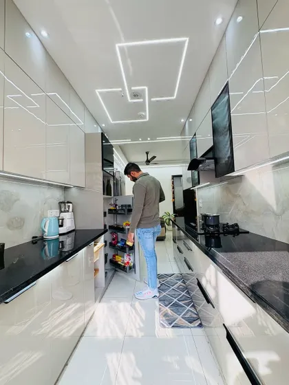 Checking the pull-out pantry unit in a newly installed modular kitchen. This feature provides a huge amount of organized storage, making it easy to see and access all your groceries.