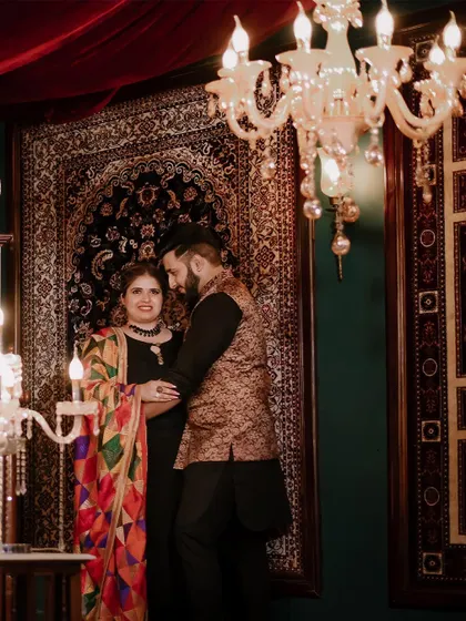 An elegant indoor pre-wedding portrait of Kushank and Sparsh, using the rich textures of carpets and warm lighting to create a royal feel.