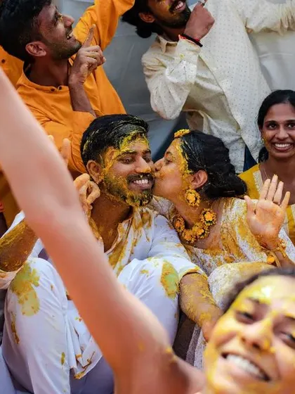 A sweet kiss amidst the happy chaos of the Haldi. We look for these small, intimate moments even during the most energetic celebrations.