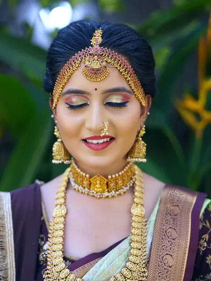 A close-up with eyes closed, focusing on the beautiful blend of eyeshadow colors. The gold and red tones create a warm, sunset-inspired effect.